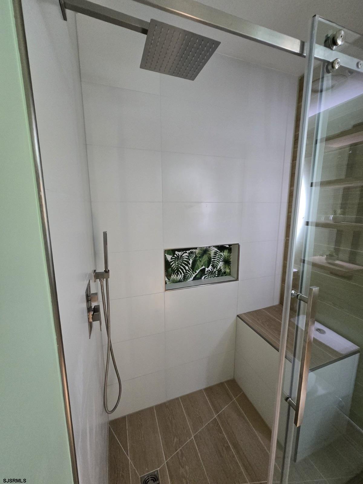 169 40th Street South, Unit 38 Brigantine, NJ 08203 - Photo 61 of 79 Modern insulated shower with light tiles that visually expand the space, featuring a striking tropic