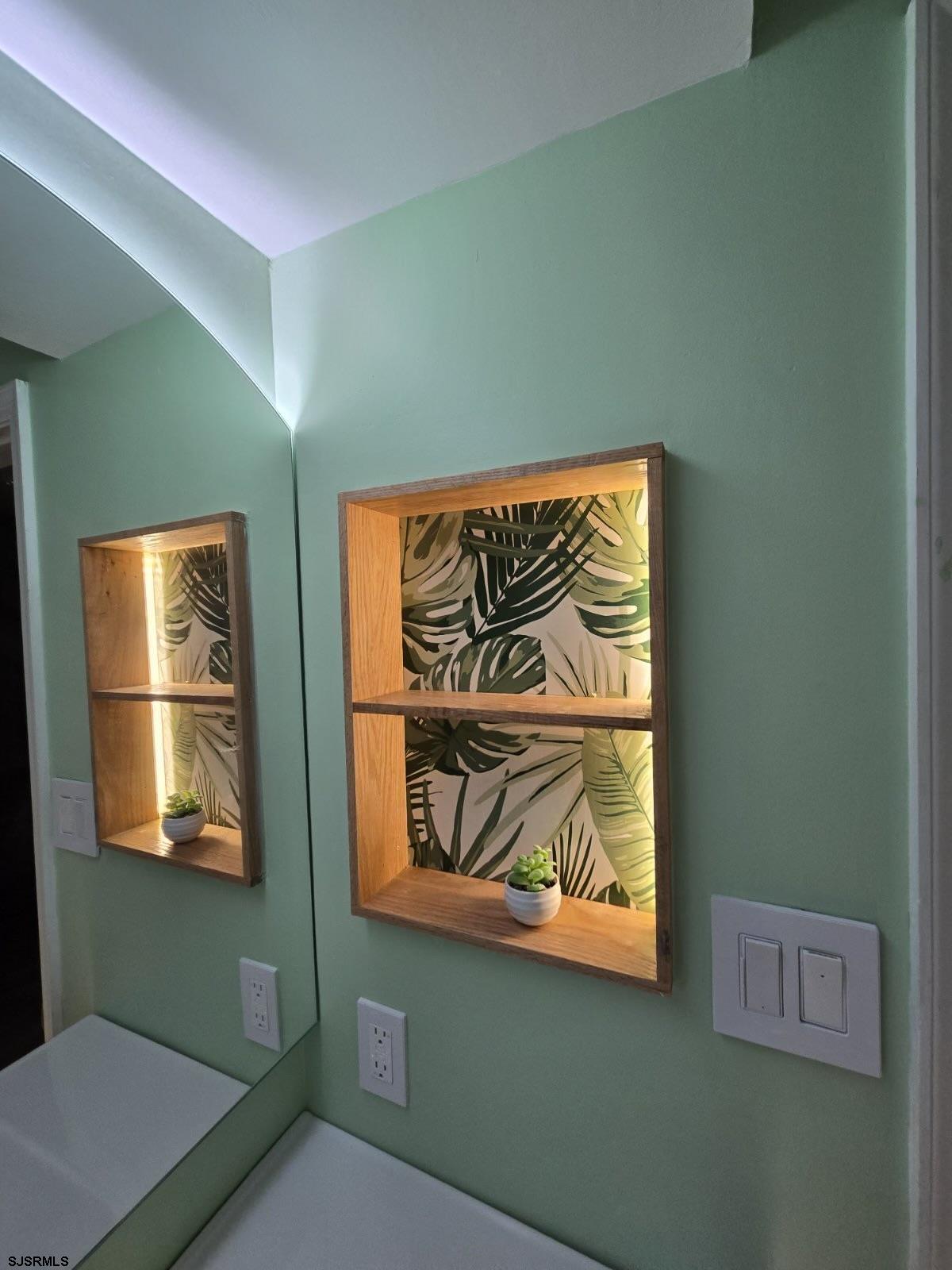169 40th Street South, Unit 38 Brigantine, NJ 08203 - Photo 63 of 79 Custom illuminated niche brings spa-like convenience and style with a serene tropical backgrop