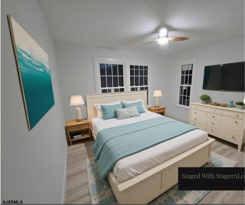 169 40th Street South, Unit 38 Brigantine, NJ 08203 - Photo 65 of 79 a bedroom with furniture and a flat screen tv