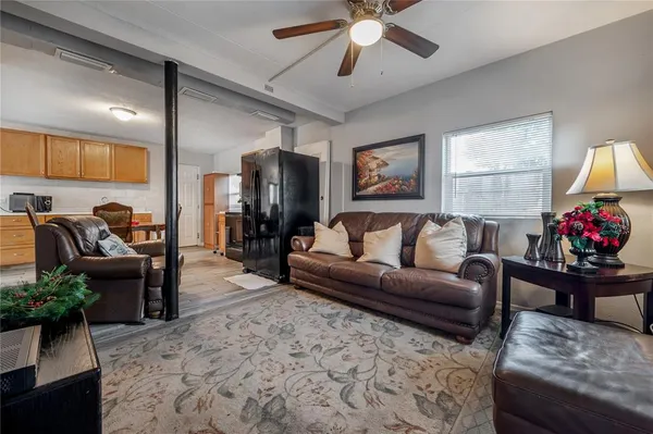a living room with furniture ceiling fan and a rug