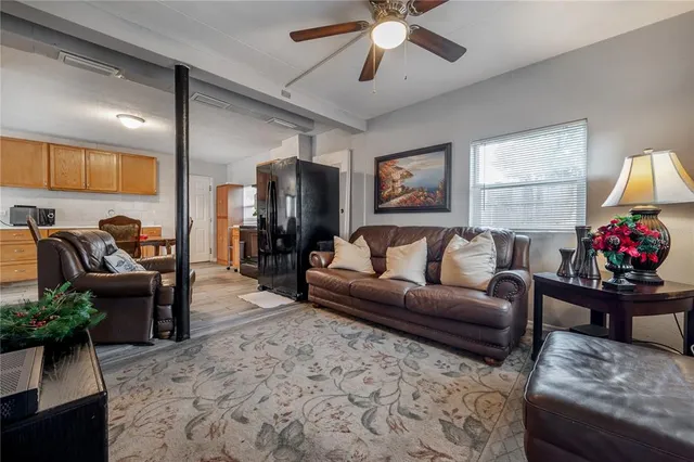 a living room with furniture ceiling fan and a rug