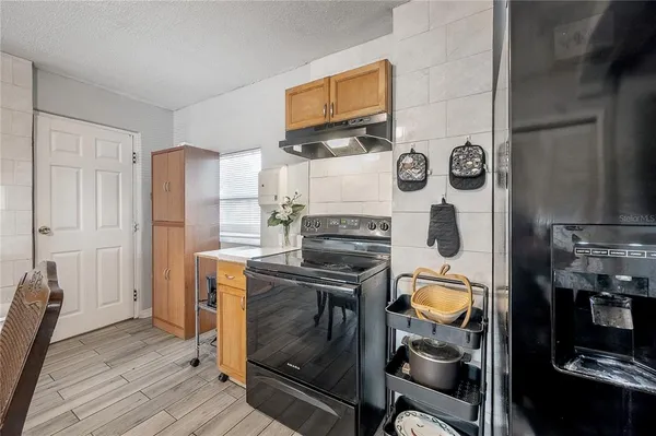 a kitchen with a stove and a refrigerator