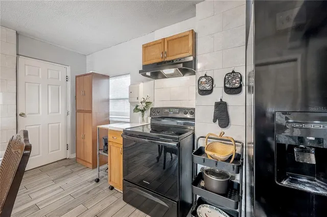 a kitchen with a stove and a refrigerator