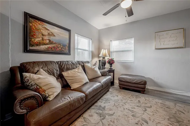 a living room with furniture a couch and window