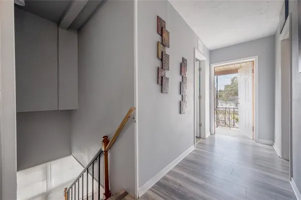 a view of a hallway with wooden floor and entryway