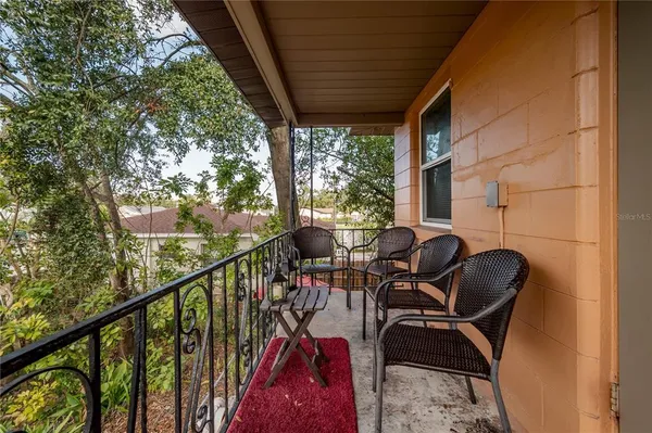 a view of balcony with furniture and garden