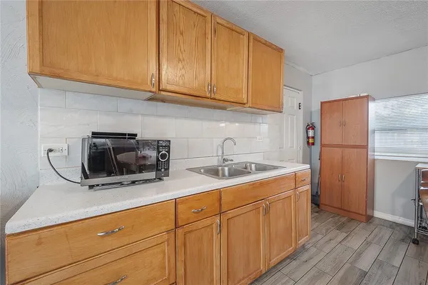 a kitchen with a sink and a refrigerator