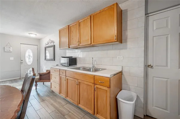 a kitchen with a sink stove and cabinets