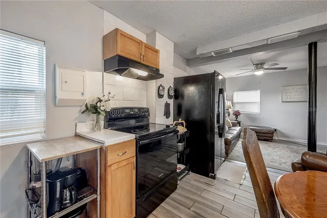 a kitchen with a refrigerator and a stove