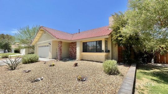 959 Jefferson Street Ridgecrest, CA 93555 - Photo 3 of 24 a front view of a house with a yard outdoor seating and pathway