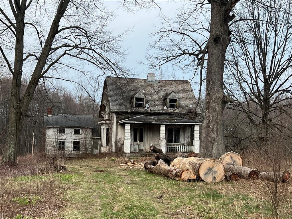 a view of a house with a yard and sitting area