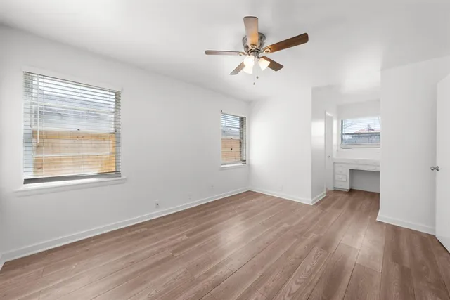 wooden floor in an empty room with a window