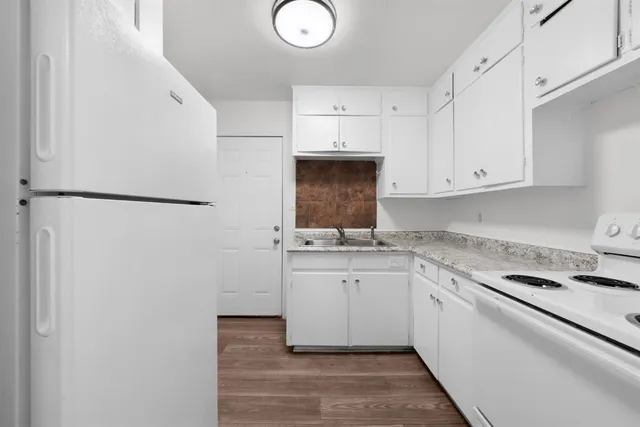 a kitchen with stainless steel appliances a refrigerator sink and cabinets