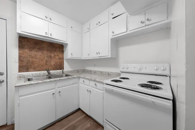 a kitchen with appliances cabinets and a sink