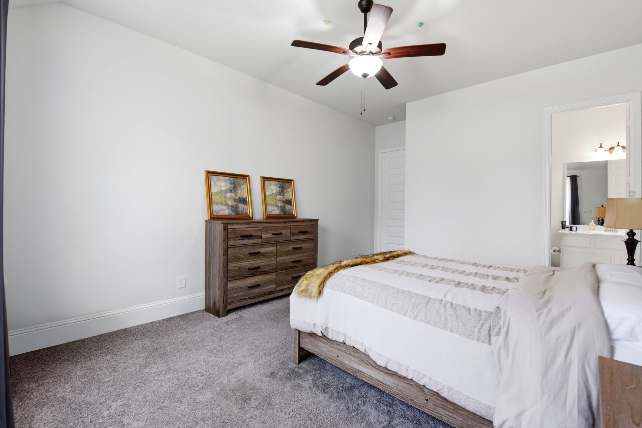 10062 South Goshawk Trail Conroe, TX 77385 - Photo 28 of 43 a bedroom with a bed and a chandelier