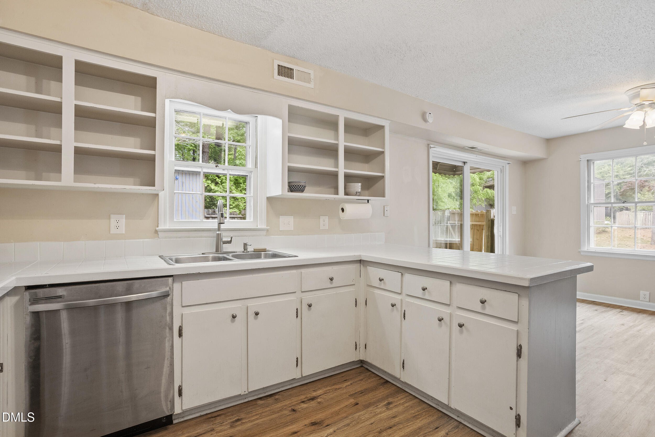 1801 Quail Ridge Road Raleigh, NC 27609 - Photo 11 of 29 a kitchen with white cabinets and a window