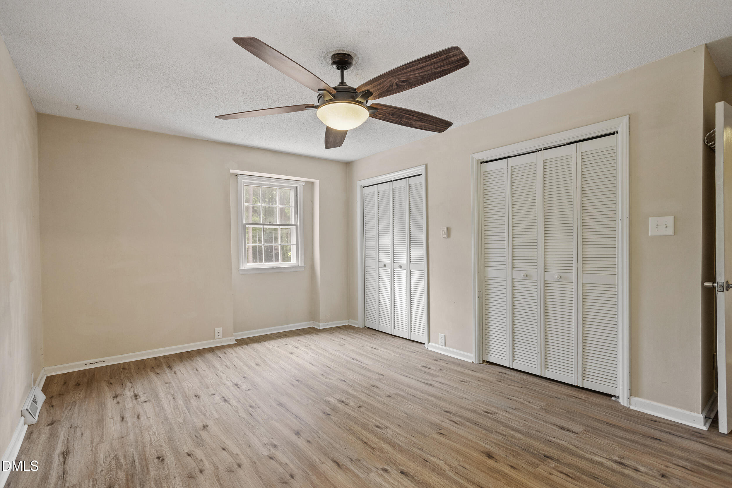 1801 Quail Ridge Road Raleigh, NC 27609 - Photo 16 of 29 a view of an empty room with wooden floor and a window