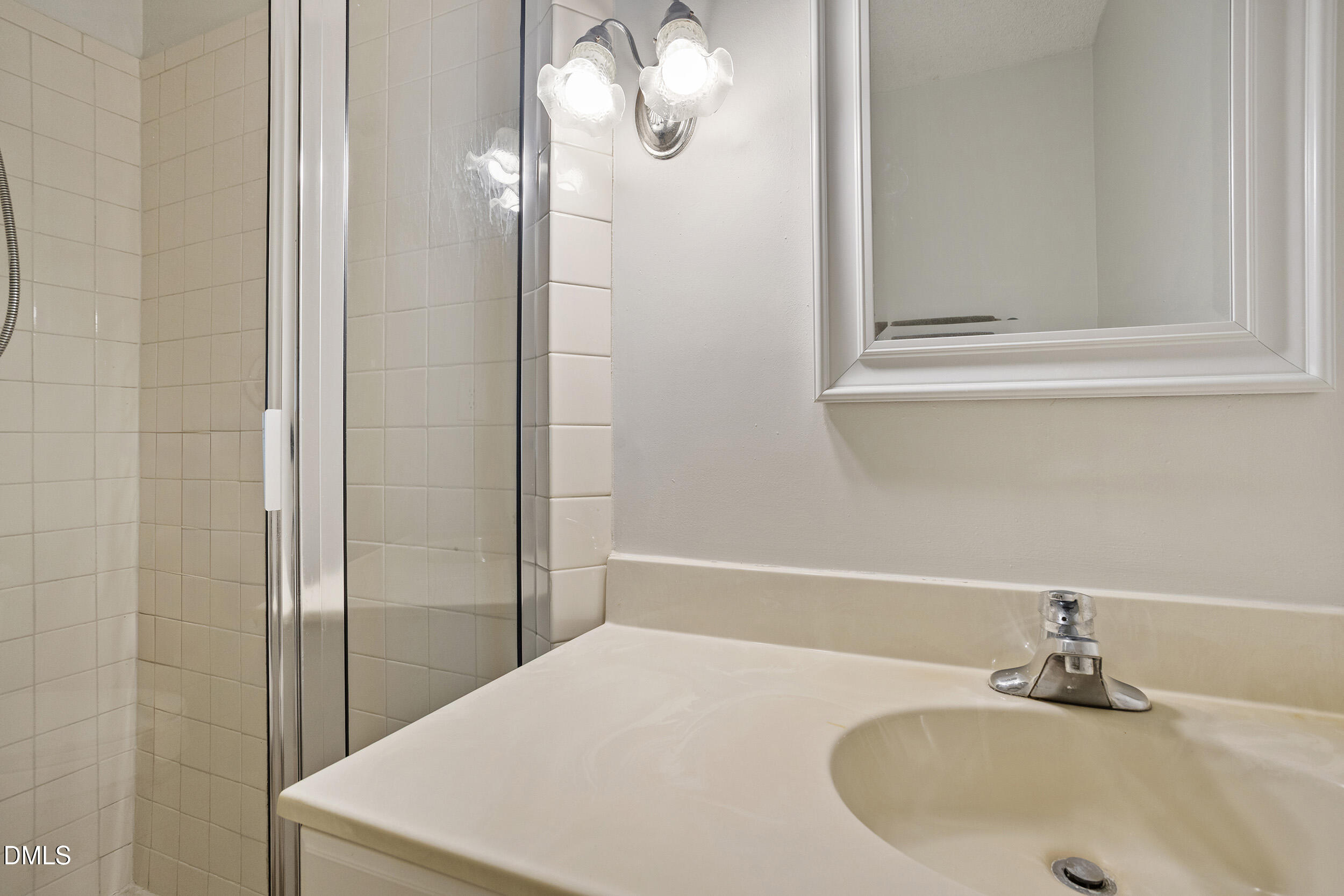 1801 Quail Ridge Road Raleigh, NC 27609 - Photo 22 of 29 a bathroom with a sink and a mirror