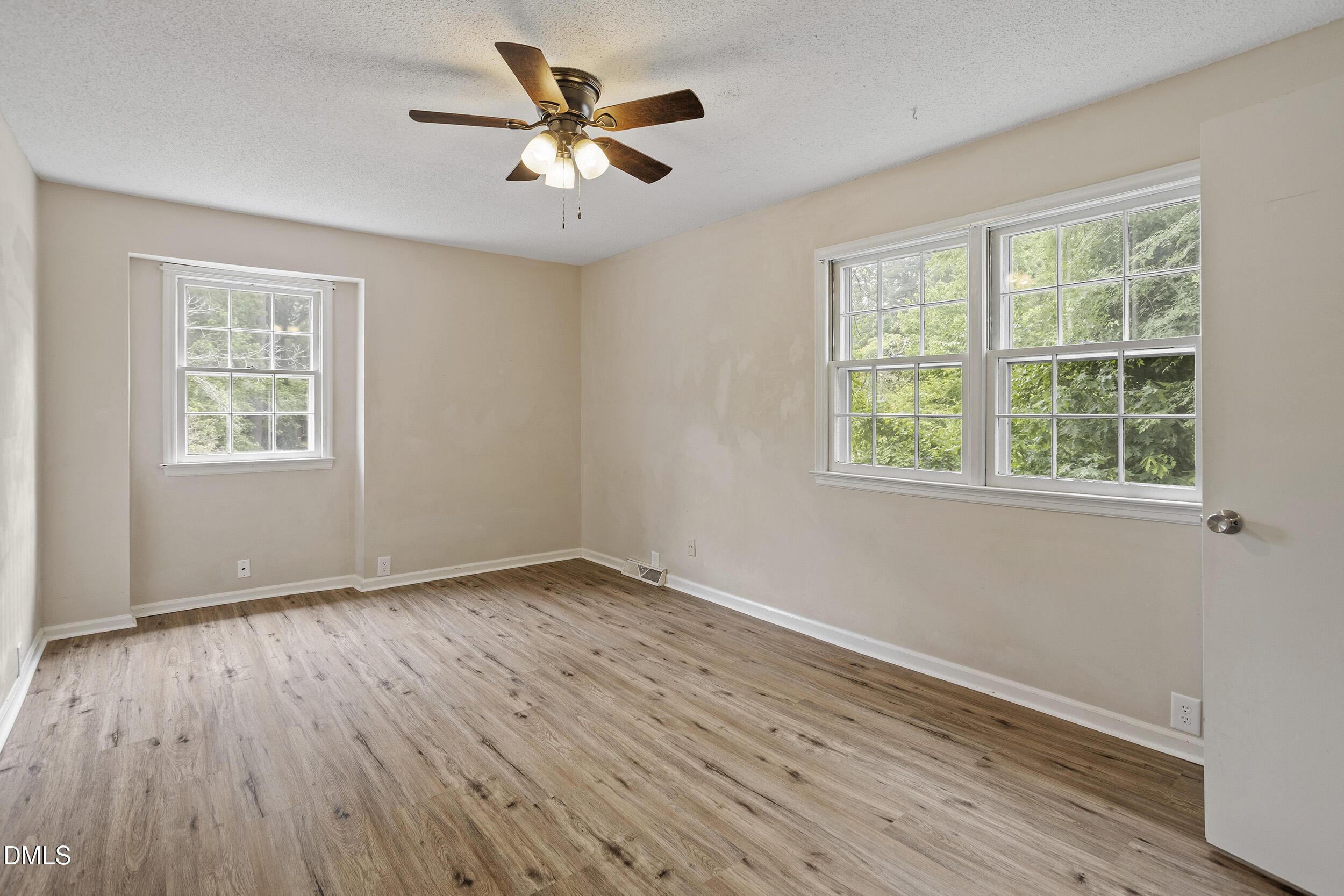 1801 Quail Ridge Road Raleigh, NC 27609 - Photo 23 of 29 a view of an empty room with wooden floor and a window
