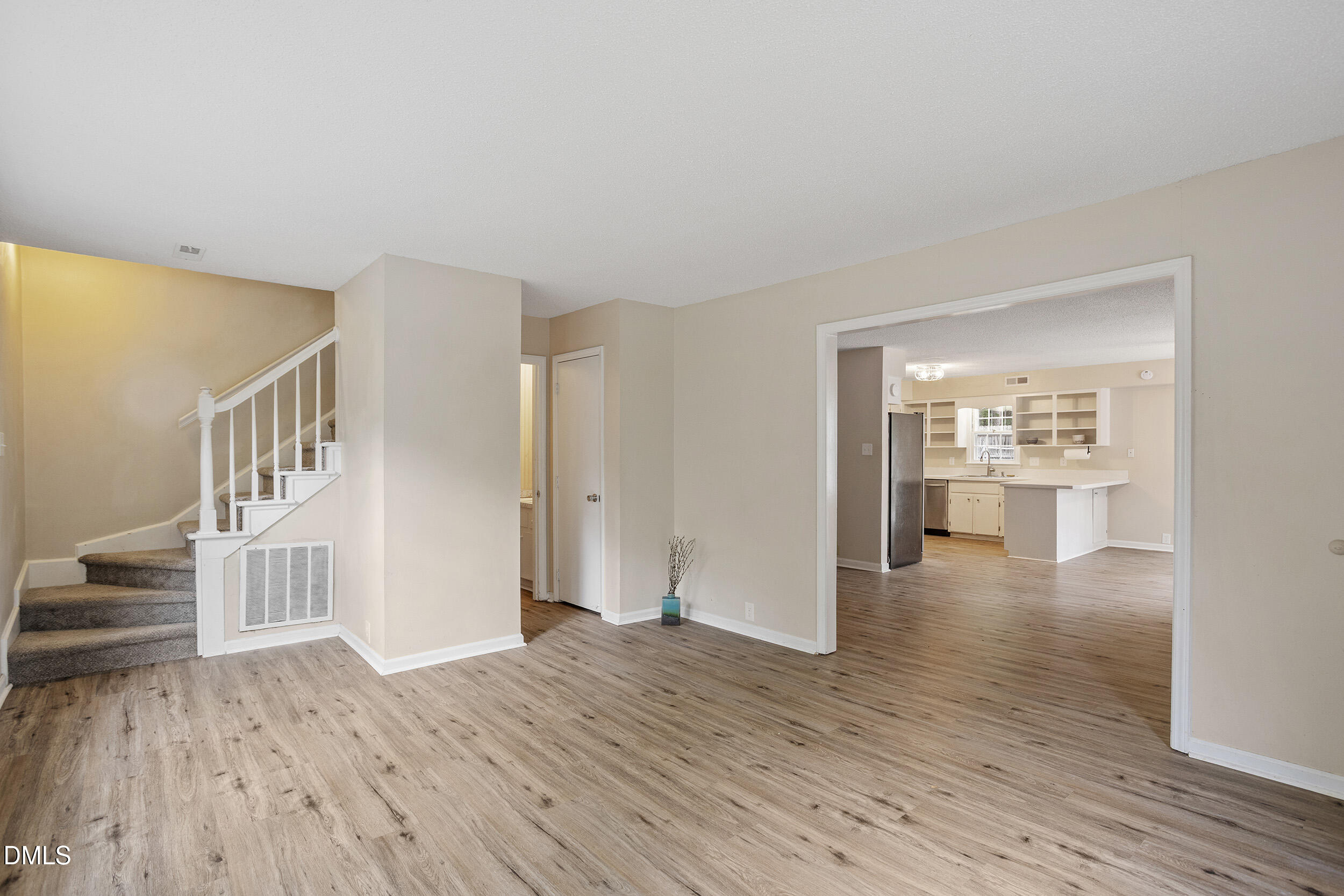 1801 Quail Ridge Road Raleigh, NC 27609 - Photo 4 of 29 a view of an empty room with wooden floor and a window