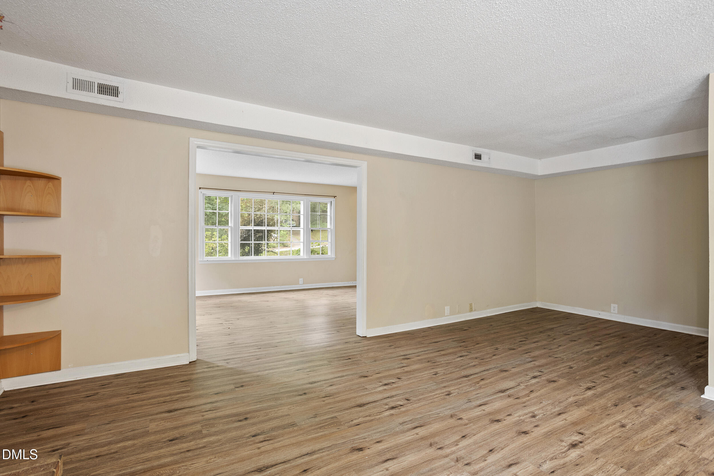 1801 Quail Ridge Road Raleigh, NC 27609 - Photo 10 of 29 a view of an empty room with wooden floor and a window
