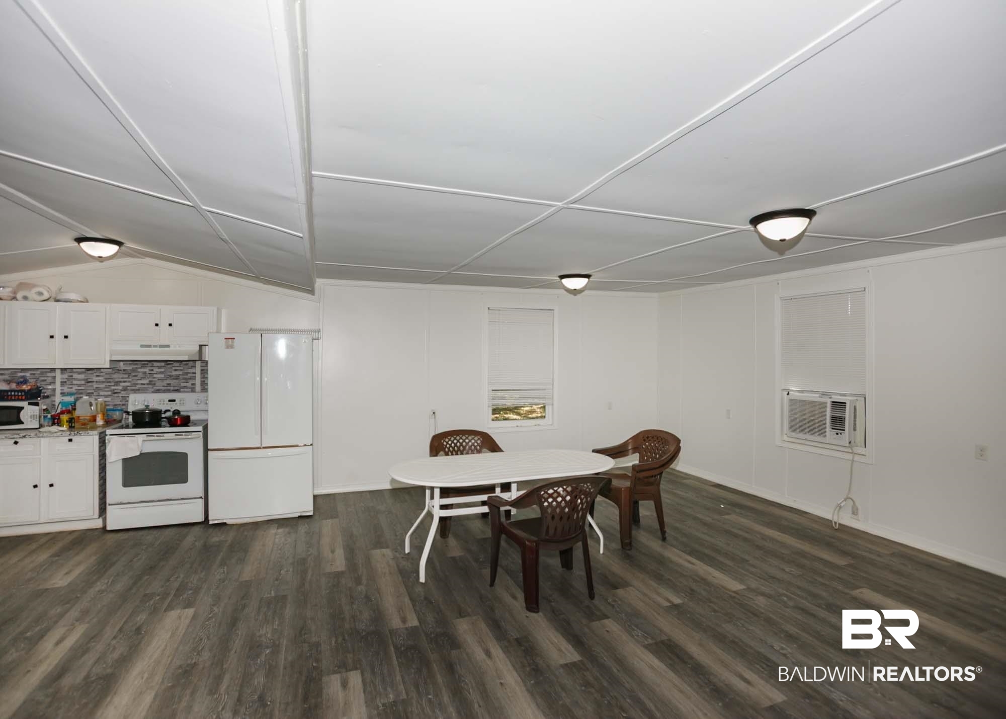 11998 Workman Avenue Foley, AL 36535 - Photo 11 of 59 Dining area featuring dark wood finished floors and baseboards