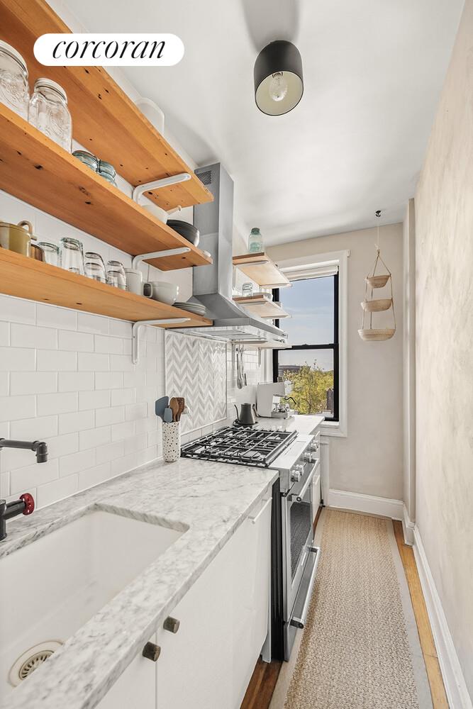 75 Prospect Park Southwest, Unit E8 Brooklyn, NY 11215 - Photo 5 of 11 a kitchen with stainless steel appliances granite countertop a sink stove and cabinets