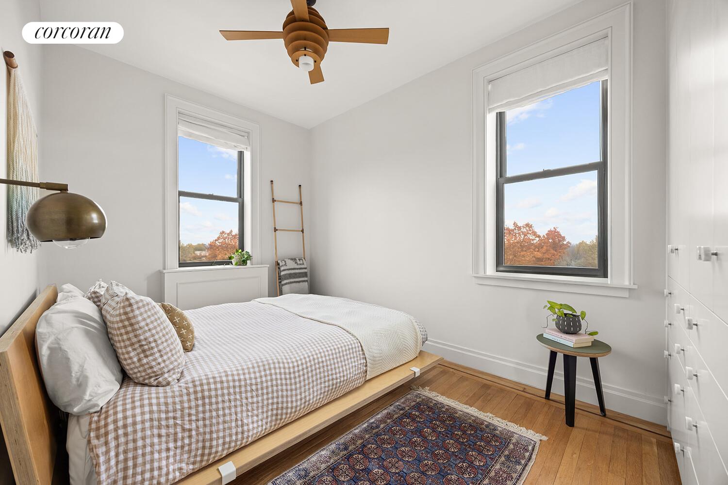 75 Prospect Park Southwest, Unit E8 Brooklyn, NY 11215 - Photo 6 of 11 a bedroom with a bed and a chandelier