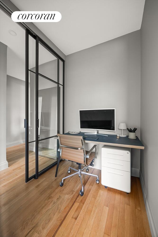 75 Prospect Park Southwest, Unit E8 Brooklyn, NY 11215 - Photo 7 of 11 a living room with a flat screen tv and furniture