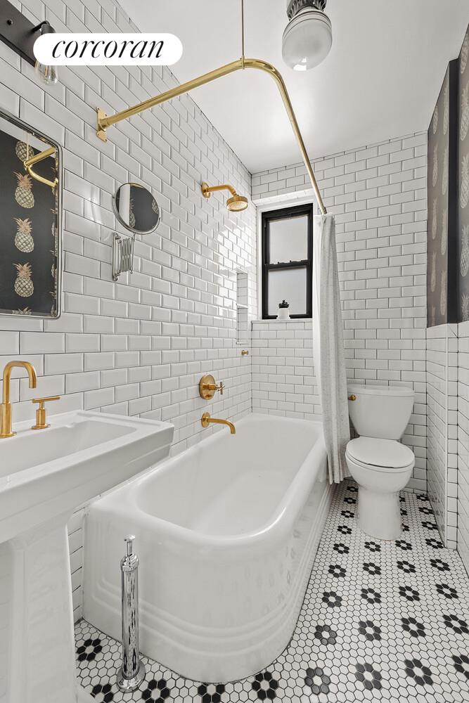 75 Prospect Park Southwest, Unit E8 Brooklyn, NY 11215 - Photo 9 of 11 a bathroom with a sink a toilet and shower