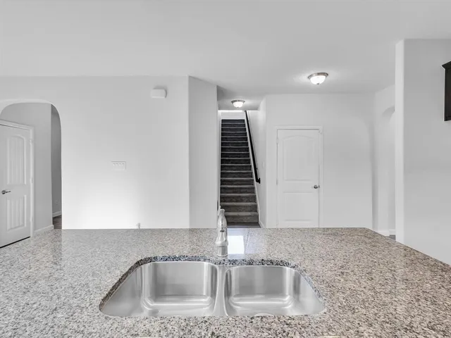 a kitchen with a sink cabinets and entryway