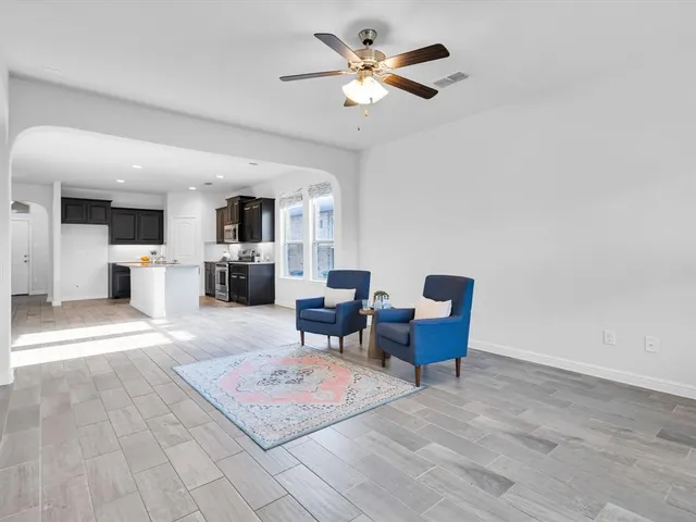a living room with furniture and a chandelier