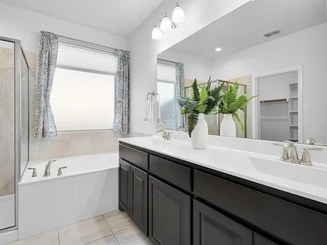a bathroom with a bathtub sink and mirror