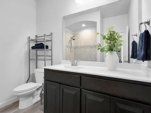 a bathroom with a sink a toilet and a mirror