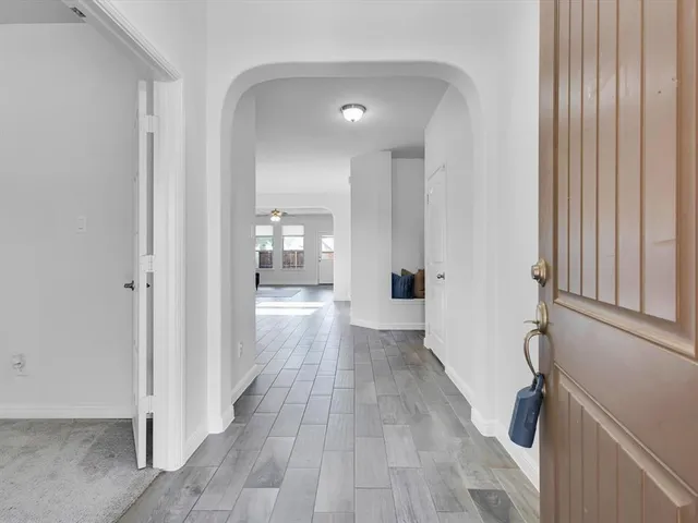 a view of hallway with wooden floor
