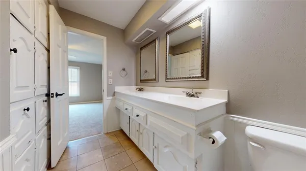 a bathroom with a tub sink and mirror