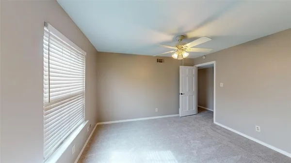 a view of a livingroom with a ceiling fan and window