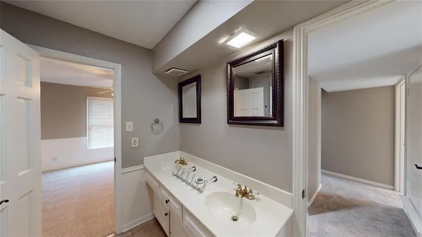 a bathroom with a sink and mirror