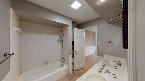 a bathroom with a bathtub and a shower