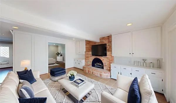 a living room with furniture a rug and a fireplace