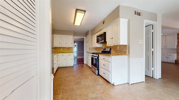 a kitchen with stainless steel appliances a refrigerator and a stove