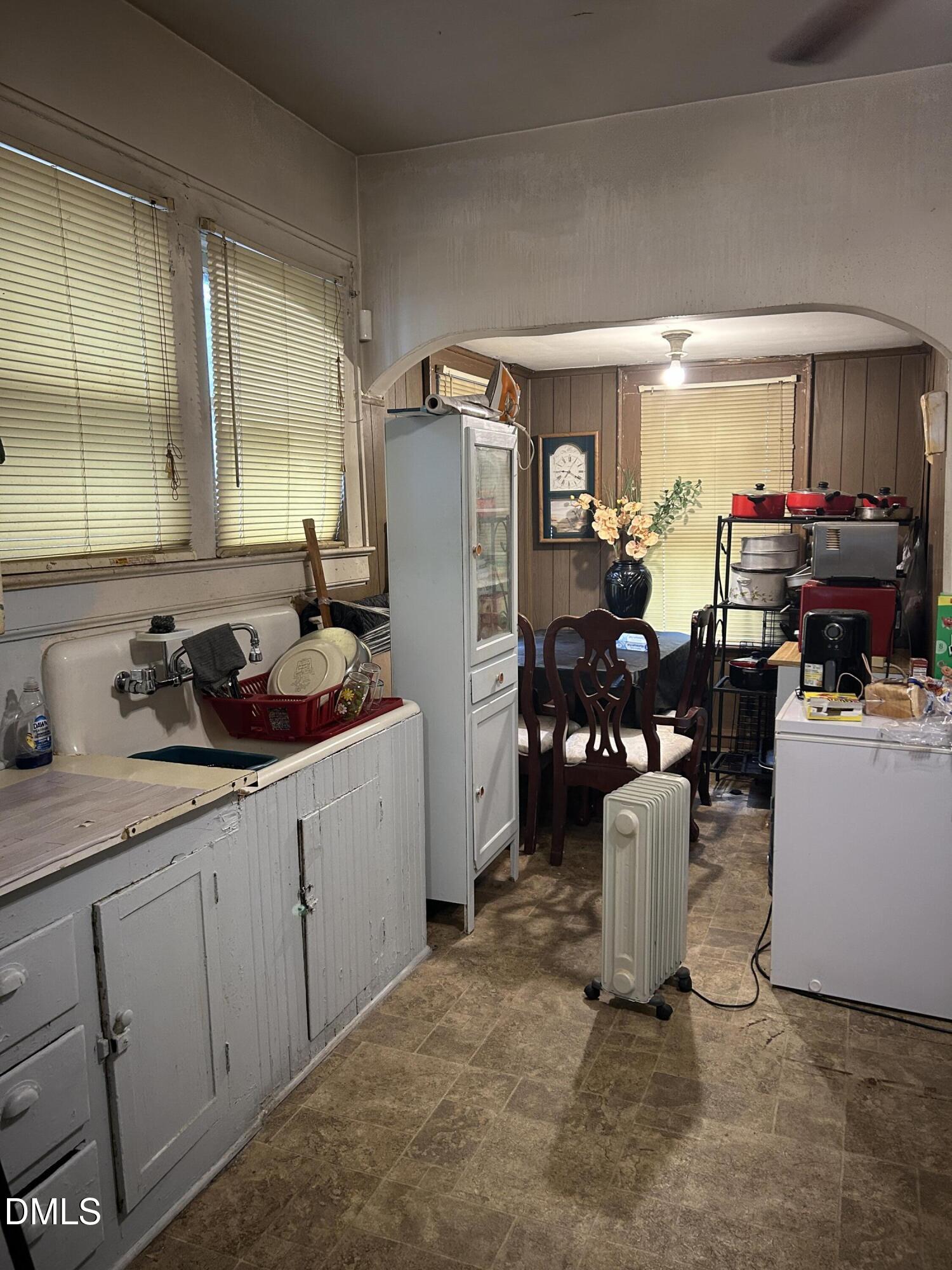 910 Chester Street Durham, NC 27701 - Photo 3 of 9 a kitchen with sink refrigerator and cabinets