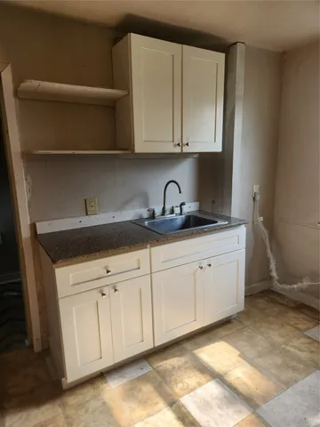a kitchen with white cabinets