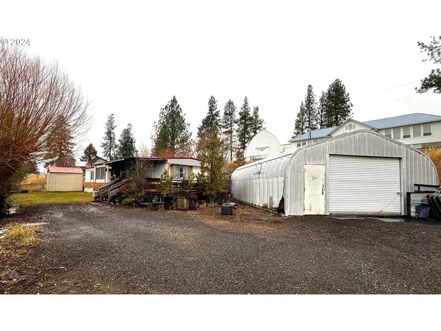 a view of a house with truck parked in front of it