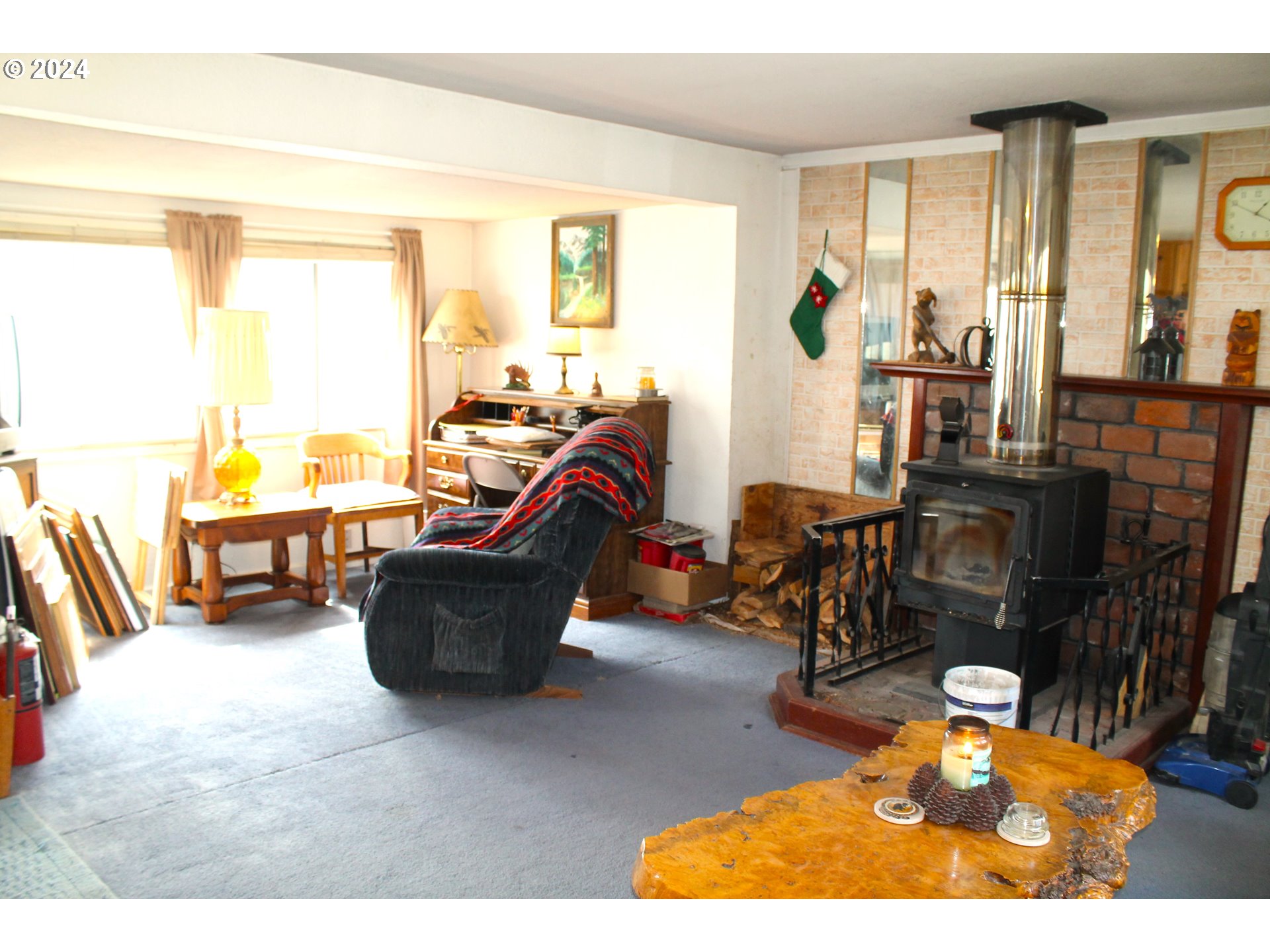 205 Camas Street Ukiah, OR 97880 - Photo 13 of 41 a living room with furniture and a floor to ceiling window