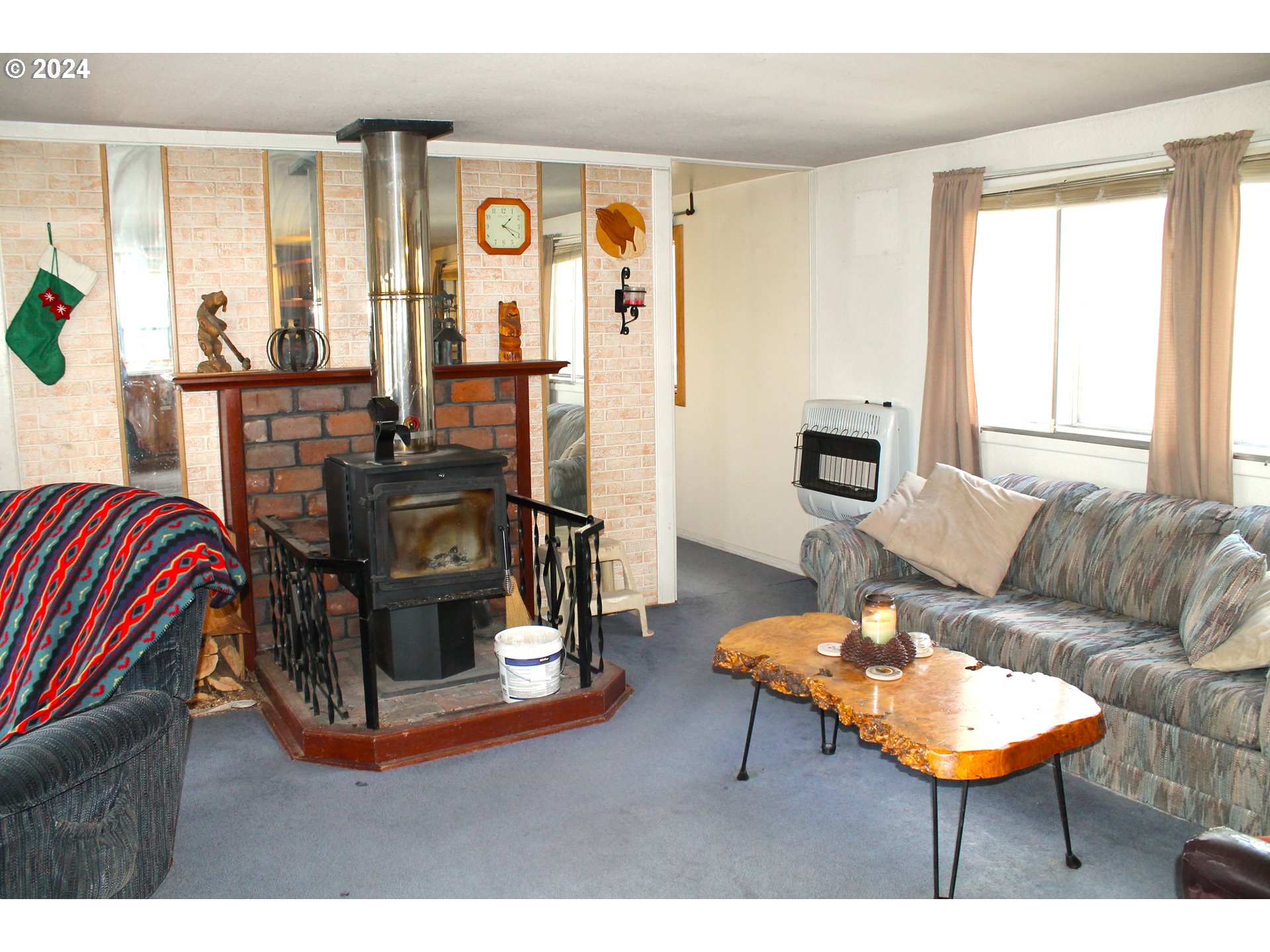 205 Camas Street Ukiah, OR 97880 - Photo 14 of 41 a living room with furniture and a fireplace