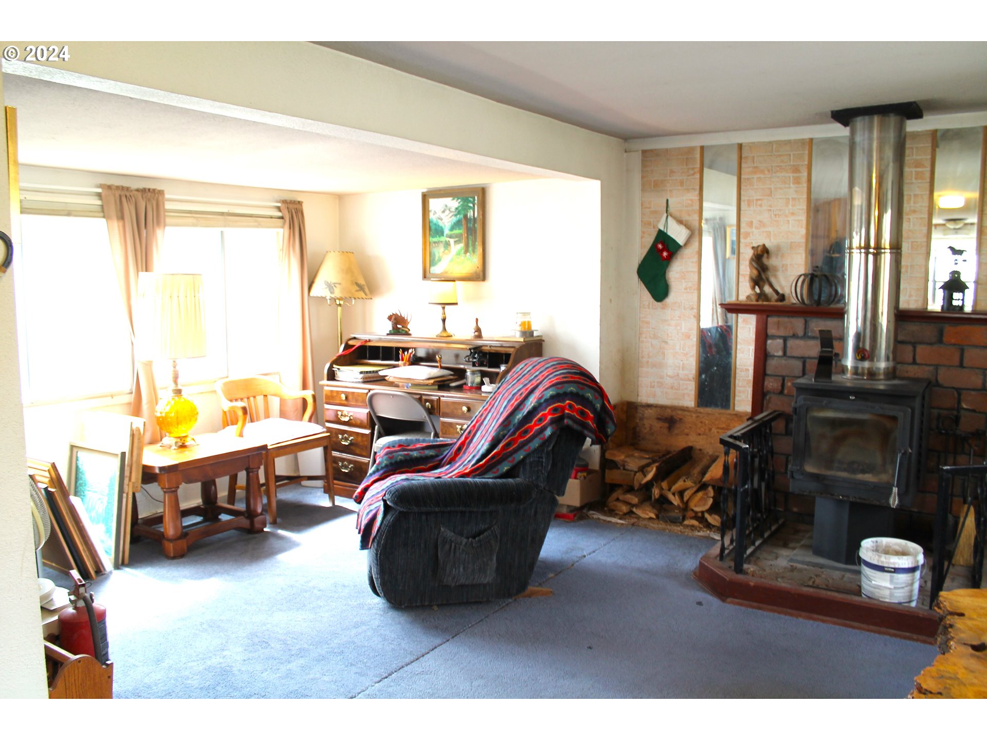 205 Camas Street Ukiah, OR 97880 - Photo 15 of 41 a living room with furniture a flat screen tv and a window
