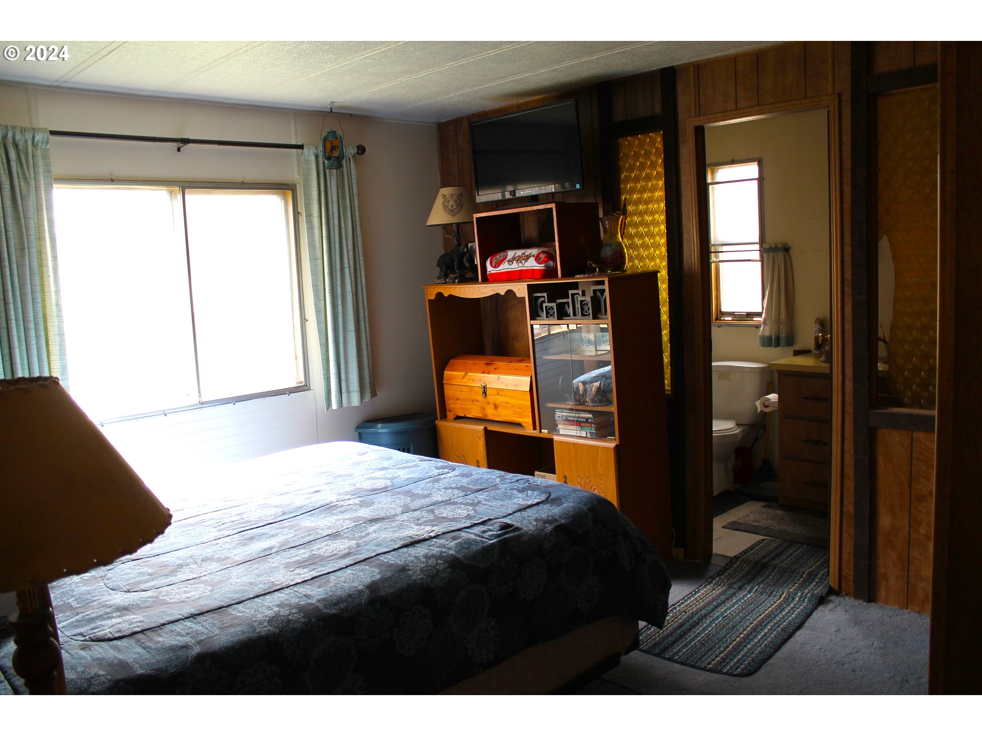 205 Camas Street Ukiah, OR 97880 - Photo 26 of 41 a bedroom with a bed and a flat tv screen on dresser