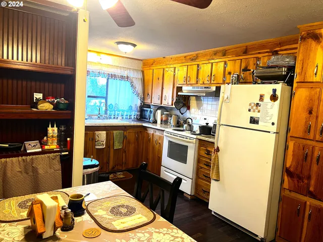 a kitchen with a refrigerator and a stove