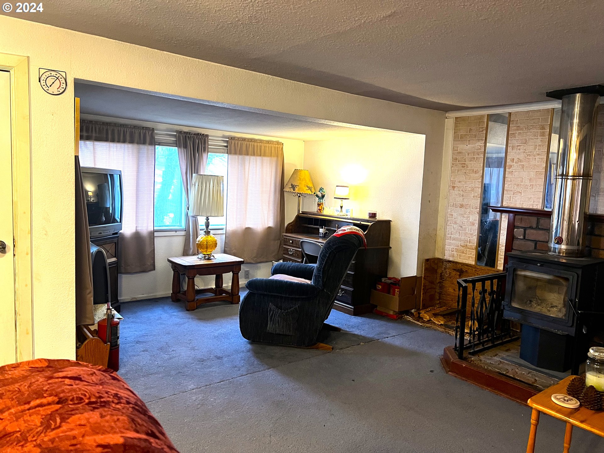 205 Camas Street Ukiah, OR 97880 - Photo 9 of 41 a living room with furniture and a flat screen tv